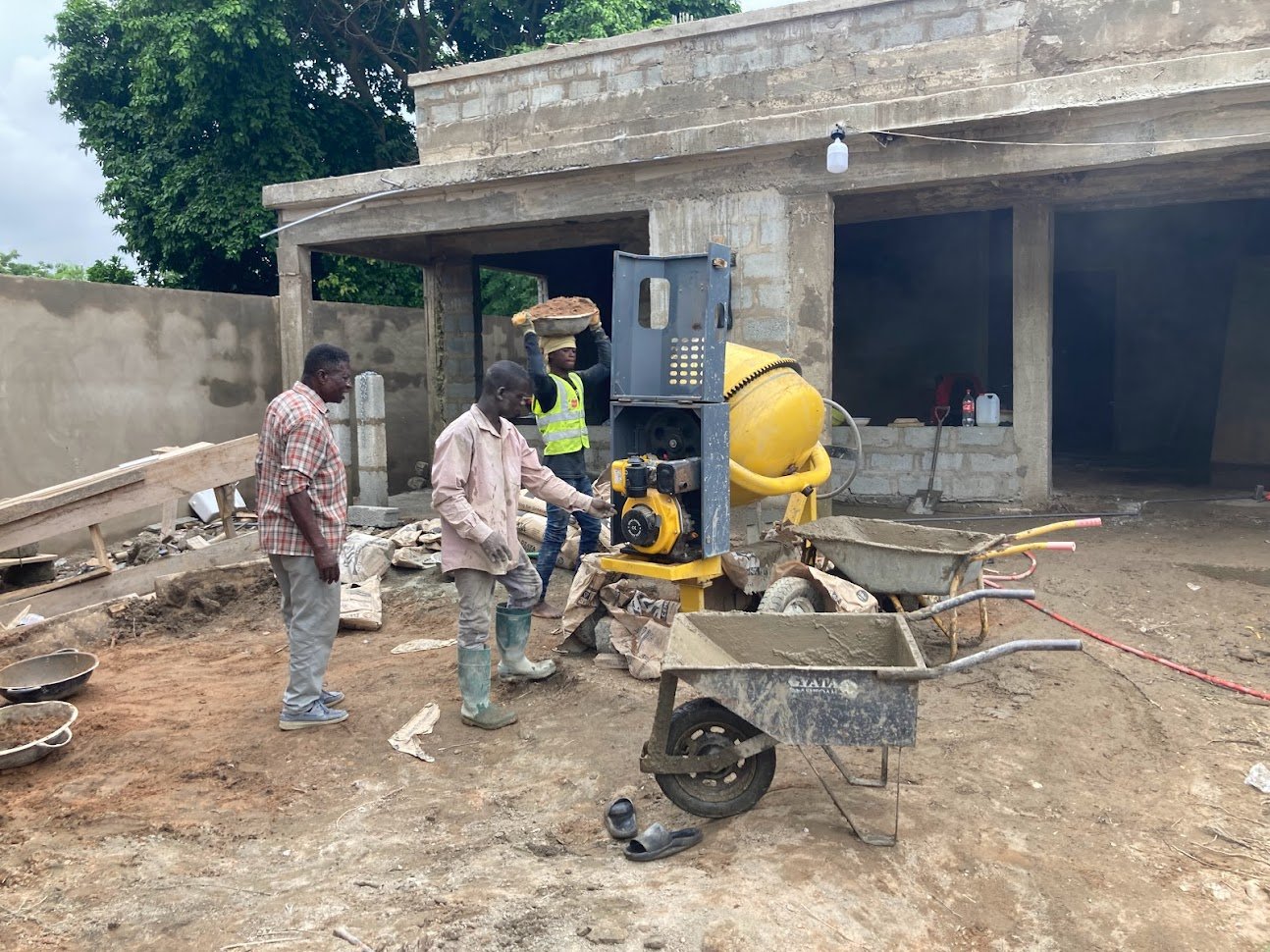 Punctum Construction workers applying plaster to exterior walls on an active project site